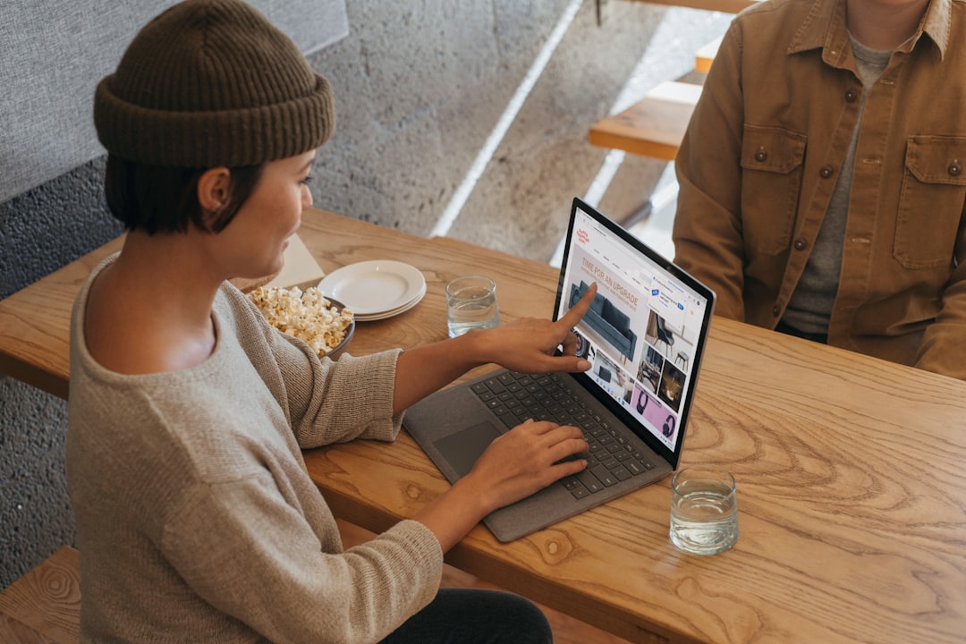 Freelancer working securely on laptop in coffee shop with VPN protection