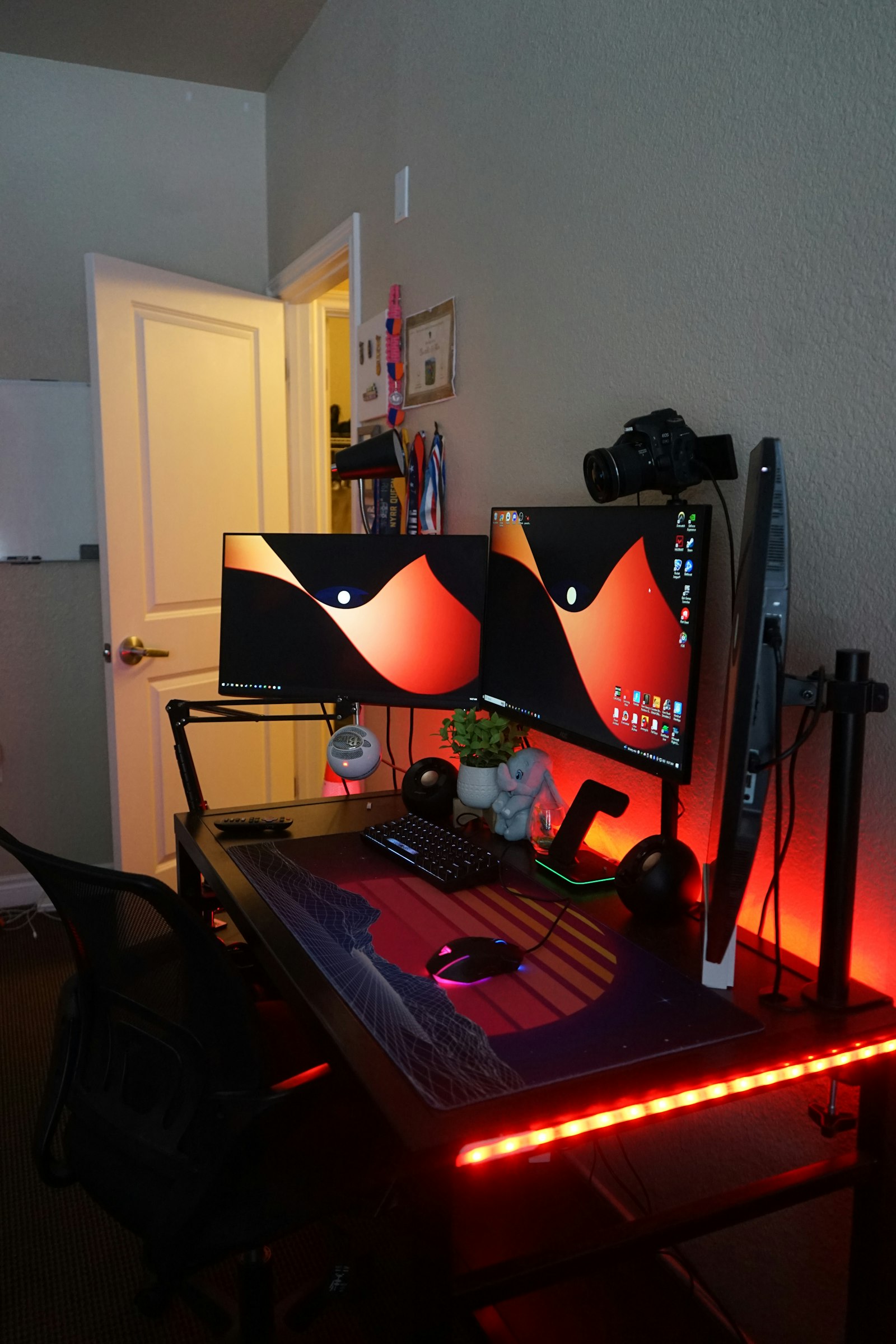 Dual-monitor RGB gaming setup with neon lighting